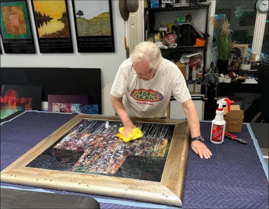 Duane Armstrong restoring a painting in his studio